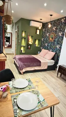 a bedroom with a bed and a table with plates on it at Studio de charme climatisé Gare Riquier in Nice