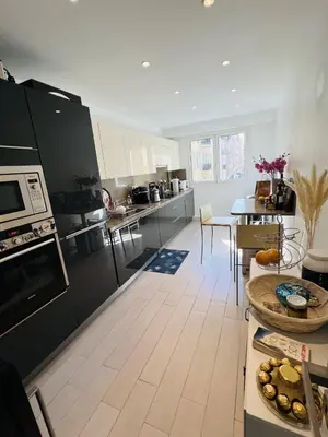a large kitchen with a table and a dining room at John Homestay Room in Nice in Nice