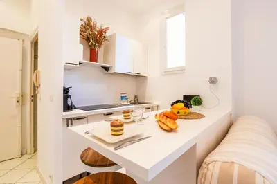 a white kitchen with a counter with food on it at LE FLORIDA AP4340 By Riviera Holiday Homes in Villefranche-sur-Mer