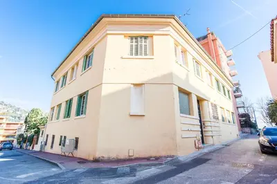 a white building on the side of a street at LE FLORIDA AP4340 By Riviera Holiday Homes in Villefranche-sur-Mer