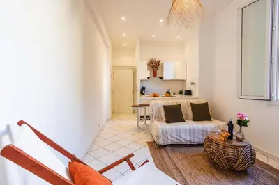 a living room with a couch and a table at LE FLORIDA AP4340 By Riviera Holiday Homes in Villefranche-sur-Mer