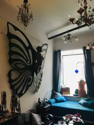 a bedroom with a blue bed with a butterfly on the wall at LOFT D ARTISTES AVEC PATIO AU PORT DE NICE in Nice