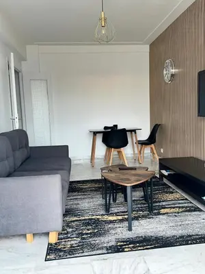 a living room with a couch and a table at Orangers Apartment in Nice