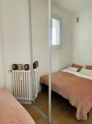 a bedroom with a mirror next to a bed at T2 Carre Or Nice Rue Pietonne in Nice