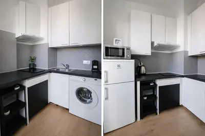 a kitchen with white cabinets and a washing machine at T2 Carre Or Nice Rue Pietonne in Nice