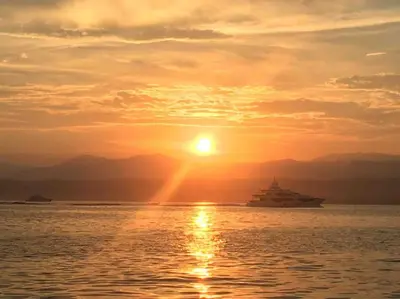 a sunset over the water with a cruise ship at Vieux-Nice : 2 pièces type loft in Nice