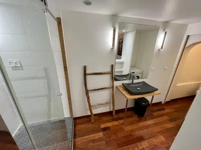 a bathroom with a sink and a mirror at Vieux-Nice : 2 pièces type loft in Nice