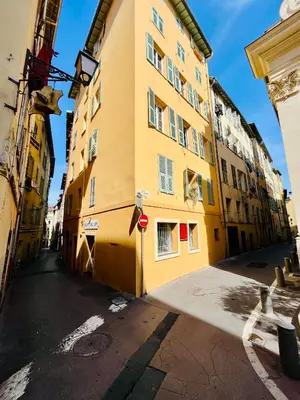 a yellow building on the side of a street at Vieux-Nice : 2 pièces type loft in Nice