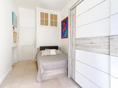 a bedroom with a bed and a sliding barn door at Apartment Hérold-2 by Interhome in Nice