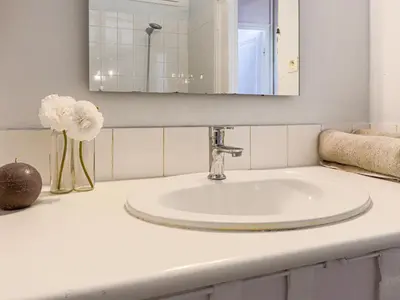 a bathroom counter with a sink and a mirror at Apartment Hérold-2 by Interhome in Nice