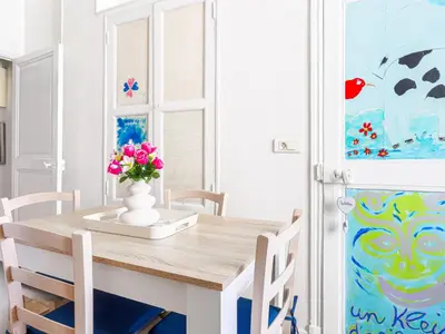a dining room table with a vase of flowers on it at Apartment Hérold-2 by Interhome in Nice