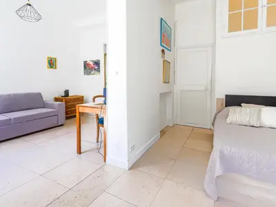a room with a bed and a couch and a table at Apartment Hérold-2 by Interhome in Nice