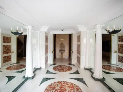 a lobby with white columns and a rug on the floor at Apartment Cros de Cagnes-1 by Interhome in Cagnes-sur-Mer