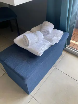 a blue couch with towels on top of it at Q&R Renting - Appartement luxueux et Suites design- Parking AC Mer in Nice
