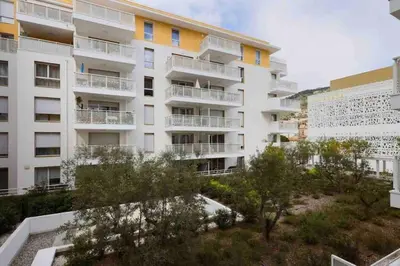 an apartment building with trees in front of it at Q&R Renting - Appartement luxueux et Suites design- Parking AC Mer in Nice
