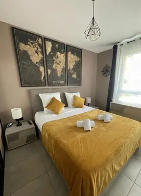 a bedroom with a large bed with two towels on it at Q&R Renting - Appartement luxueux et Suites design- Parking AC Mer in Nice