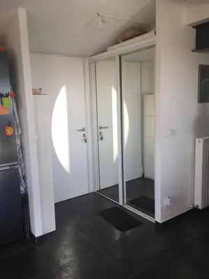 a room with glass doors and a black floor at 3 pièces dans le ciel in Gattières