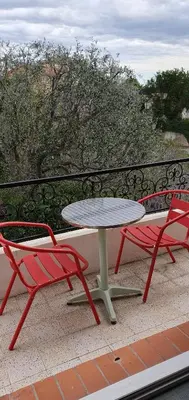 a table and two chairs sitting on a balcony at 2 pièces calme et fonctionnel in Cagnes-sur-Mer