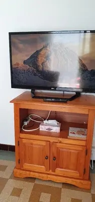 a flat screen tv sitting on top of a wooden stand at 2 pièces calme et fonctionnel in Cagnes-sur-Mer
