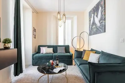 a living room with a green couch and a table at MY CASA - GESU - 2 bedrooms in Old Town - Gesu Square in Nice