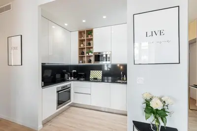 a kitchen with white cabinets and a vase of flowers at MY CASA - GESU - 2 bedrooms in Old Town - Gesu Square in Nice