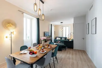 a dining room and living room with a table and chairs at MY CASA - GESU - 2 bedrooms in Old Town - Gesu Square in Nice