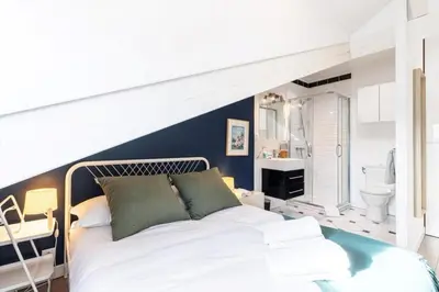 a bedroom with a white bed and a bathroom at MY CASA - DEROULEDE - Superb Studio Suite w AC Downtown in Nice