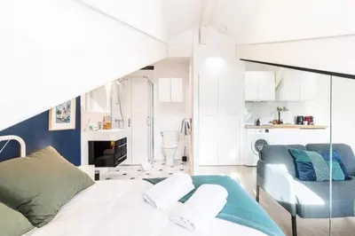 a bedroom with a bed and a couch and a chair at MY CASA - DEROULEDE - Superb Studio Suite w AC Downtown in Nice