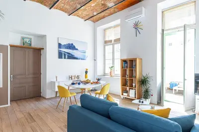 a living room with a blue couch and a table at MY CASA - GUBERNATIS - Beautiful Duplex with terrace in Nice