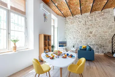 a living room with a white table and yellow chairs at MY CASA - GUBERNATIS - Beautiful Duplex with terrace in Nice