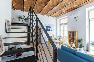 a living room with a staircase and a blue couch at MY CASA - GUBERNATIS - Beautiful Duplex with terrace in Nice