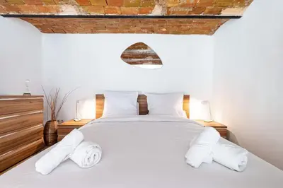 a bedroom with a white bed with two pillows at MY CASA - GUBERNATIS - Beautiful Duplex with terrace in Nice