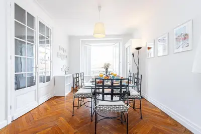 a white dining room with a table and chairs at MY CASA - JOFFRE 38 - Spacious one bedroom apartment in Nice
