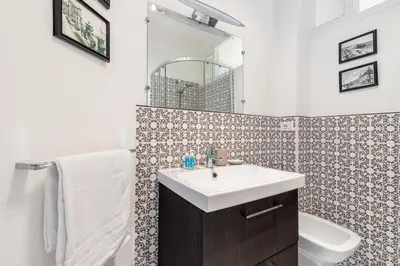 a bathroom with a sink and a toilet and a mirror at MY CASA - JOFFRE 38 - Spacious one bedroom apartment in Nice