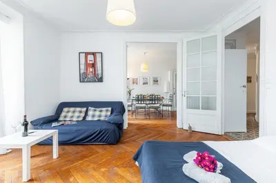 a bedroom with a blue couch and a living room at MY CASA - JOFFRE 38 - Spacious one bedroom apartment in Nice