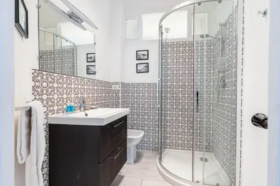a bathroom with a shower and a sink and a toilet at MY CASA - JOFFRE 38 - Spacious one bedroom apartment in Nice