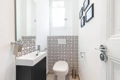 a white bathroom with a toilet and a sink at MY CASA - JOFFRE 38 - Spacious one bedroom apartment in Nice