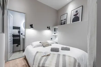 a white bedroom with a large white bed with two pillows at MY CASA - LA CROIX - Old Town Modern apartment - 2 bedrooms in Nice