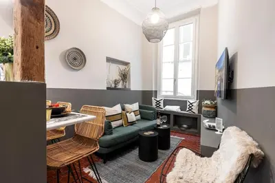 a living room with a green couch and a table at MY CASA - LA CROIX - Old Town Modern apartment - 2 bedrooms in Nice