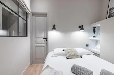 a white bedroom with a bed and a window at MY CASA - LA CROIX - Old Town Modern apartment - 2 bedrooms in Nice