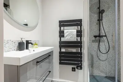 a bathroom with a sink and a shower with a mirror at MY CASA - LA CROIX - Old Town Modern apartment - 2 bedrooms in Nice