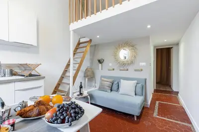 a kitchen and living room with a blue couch at MY CASA - PREFECTURE 15 - Old Town Duplex 2 double beds in Nice