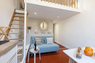 a living room with a blue couch and a staircase at MY CASA - PREFECTURE 15 - Old Town Duplex 2 double beds in Nice