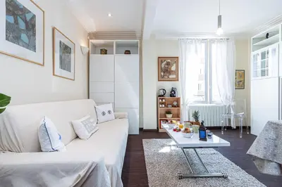 a living room with a white couch and a table at MY CASA - STALINGRAD 32 - Cosy Apartement close old Port in Nice