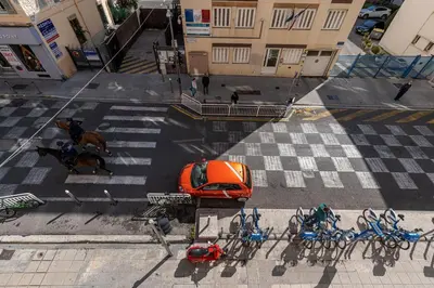 an orange car is parked on a city street at MY CASA - STALINGRAD 32 - Cosy Apartement close old Port in Nice