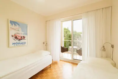 a white room with two beds and a window at EXCEPTIONNEL 4 pieces vue panoramique baie des anges proche plage in Nice