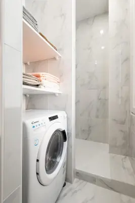a white laundry room with a washing machine at Modern Apartment - Promenade des Anglais in Nice in Nice