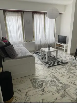 a living room with a couch and a table at Studio 50 m de la mer - Centre - Proche mer in Nice
