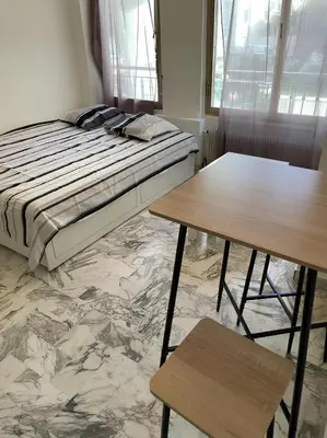 a bedroom with a bed and two tables at Studio 50 m de la mer - Centre - Proche mer in Nice