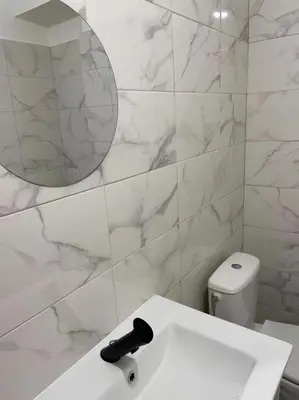 a white bathroom with a sink and a mirror at Studio 50 m de la mer - Centre - Proche mer in Nice